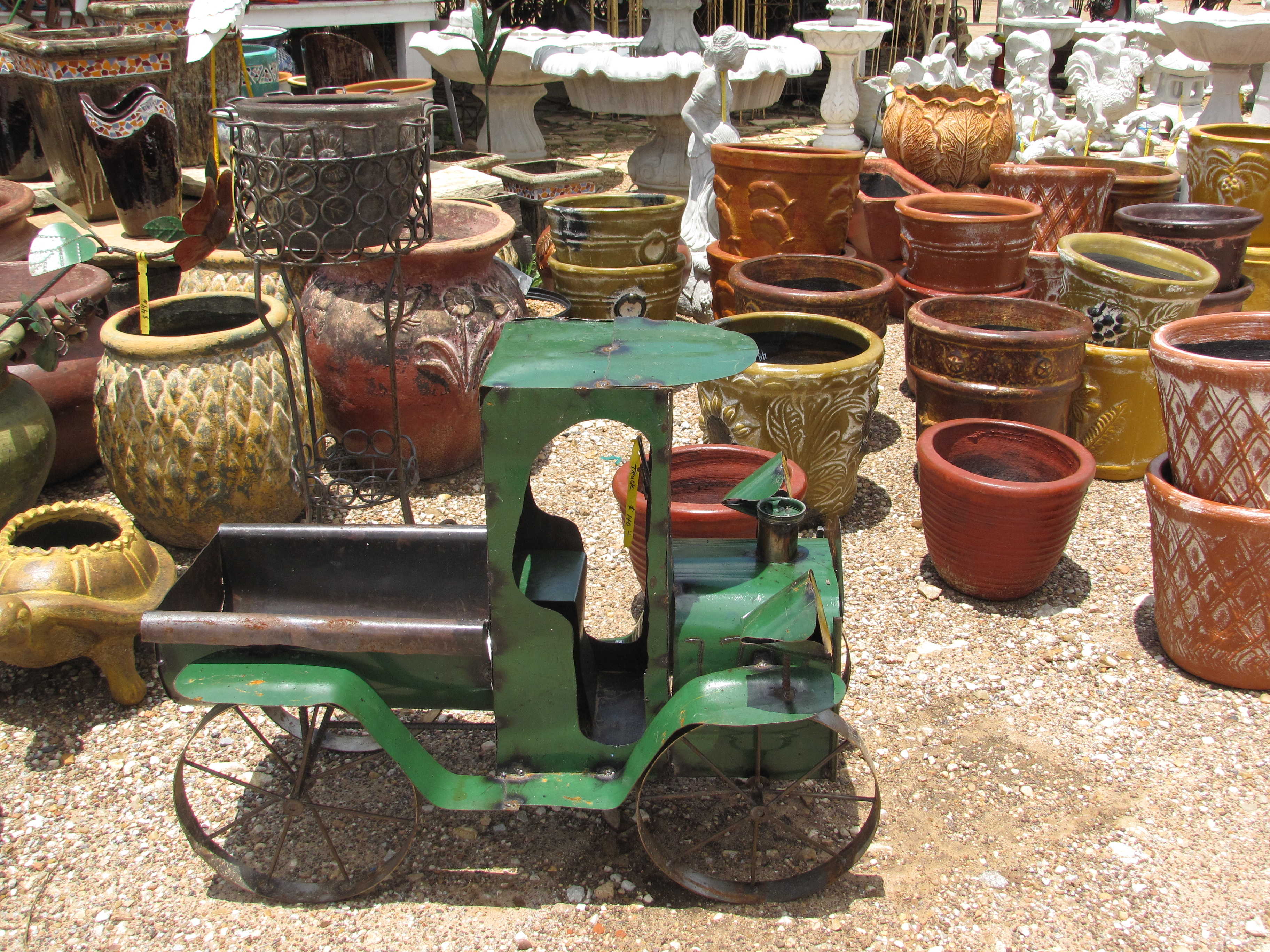 Many kinds of yard decor such as iron, cement and pottery at Madison Gardens Nursery, Spring, TX.